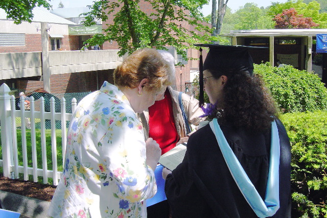 Leah, Mom & Grandma checking out diploma